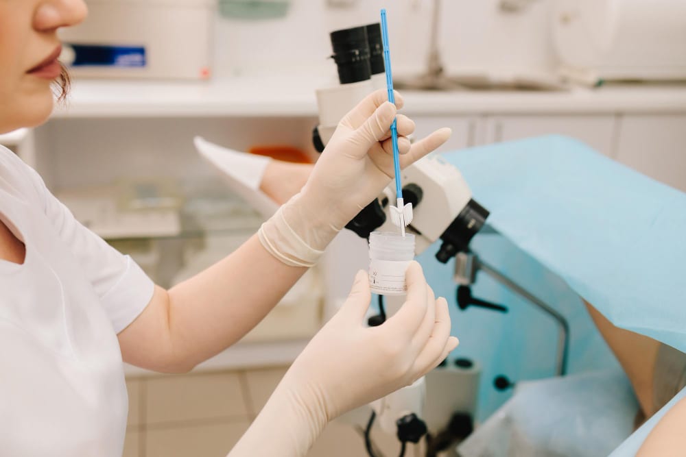 Clinician preparing a cervical screening sample in a gynaecology room