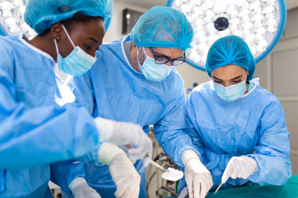 Surgical team in gowns and masks operating in theatre